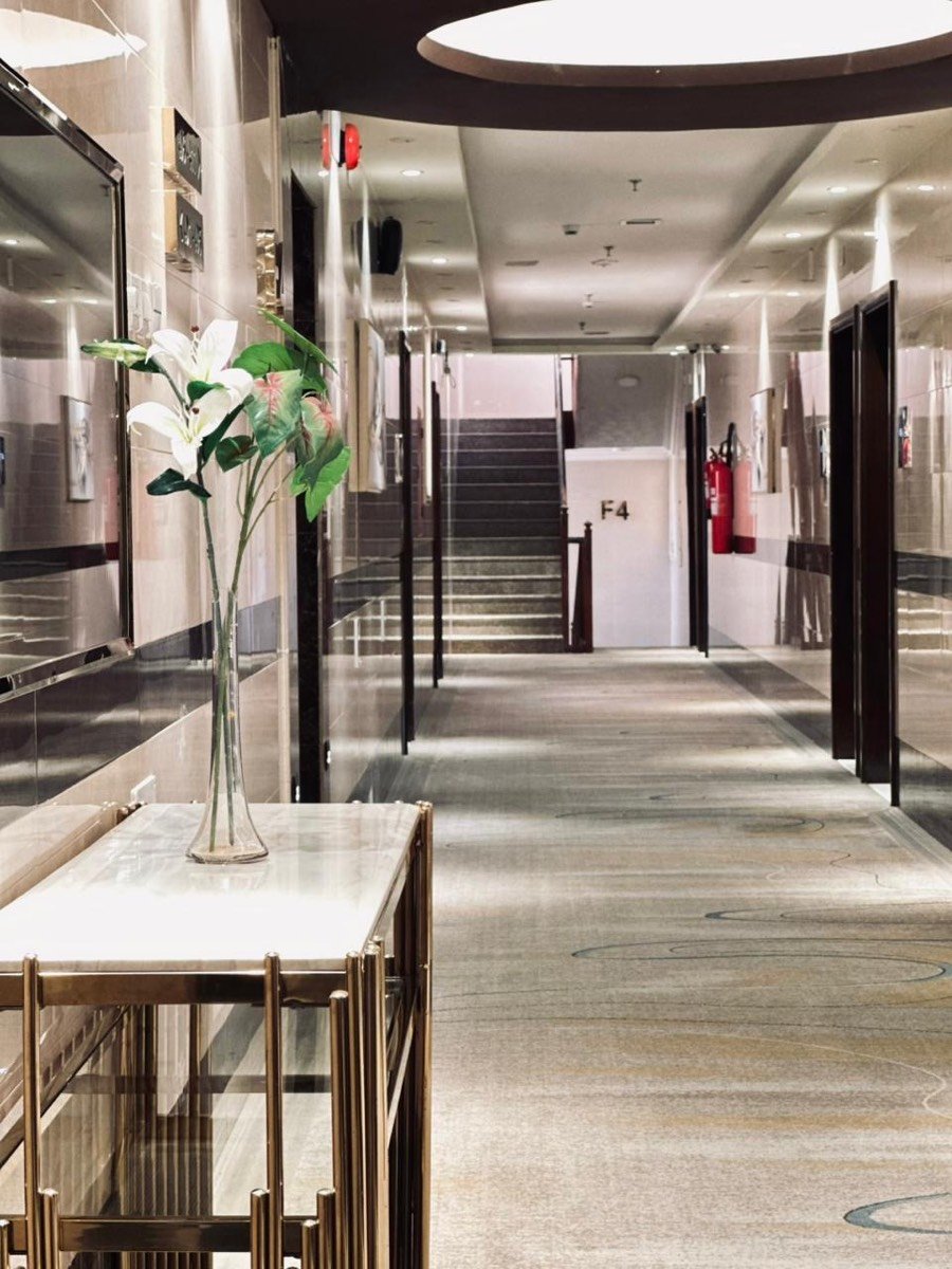 The hotel corridor, marble floor and console table